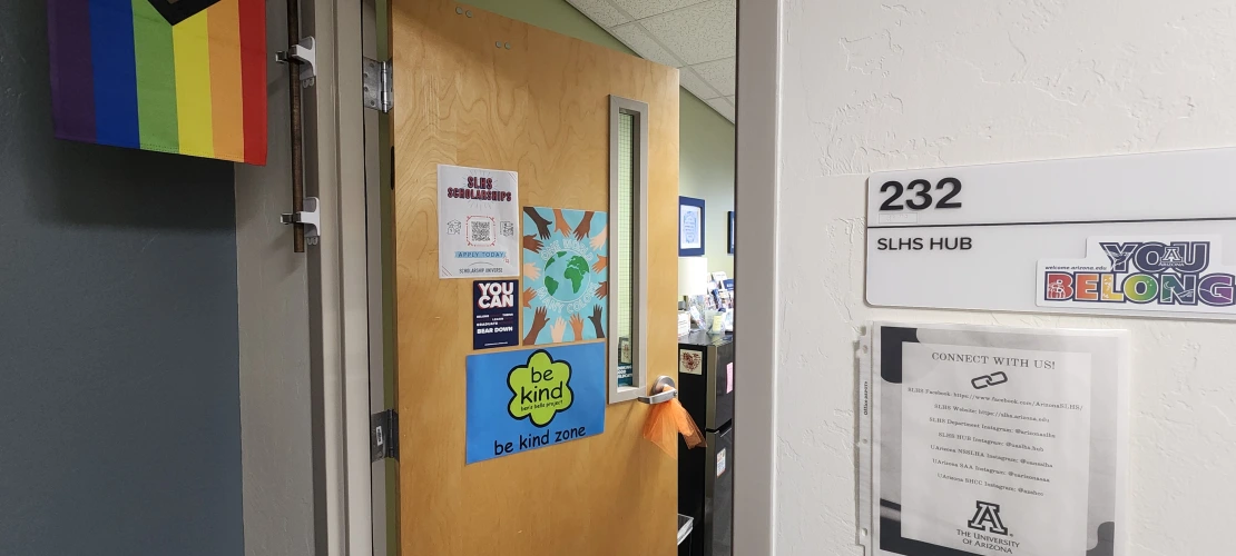 SLHS Room 232 door open showing door sign with progressive pride flag
