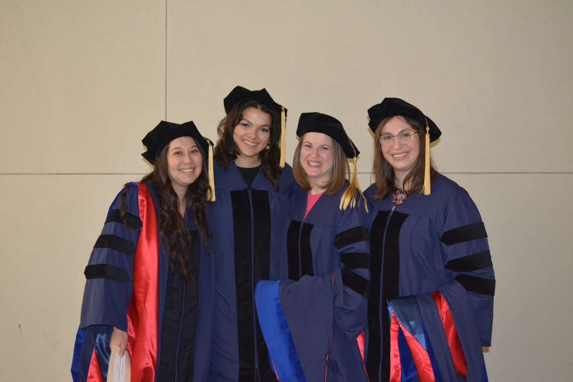 4 students in regalia