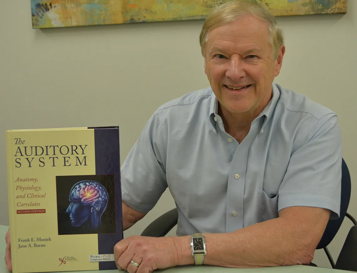 Dr. Frank Musiek with his new textbook Dr. Frank Musiek with his new textbook