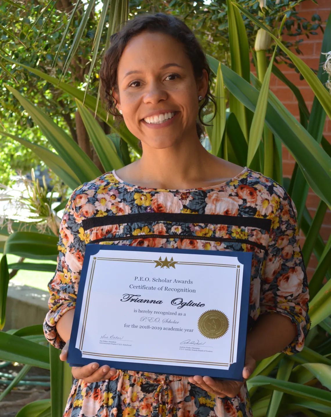 Trianna Oglivie holding her PEO Award Trianna Oglivie holding her PEO Award