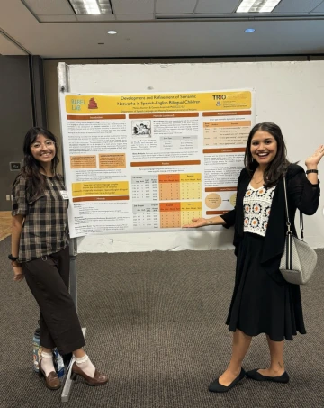 Dr Arizmendi and Melissa Romero posed in front of their research poster